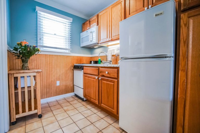 Photo of kitchen with fridge, stove and sink