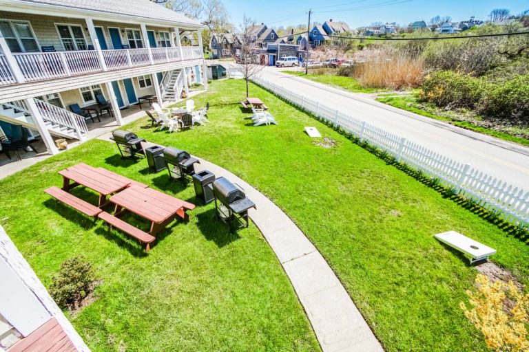 Photo of resort with barbecue grills and picnic tables